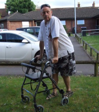 Andy using a walker frame